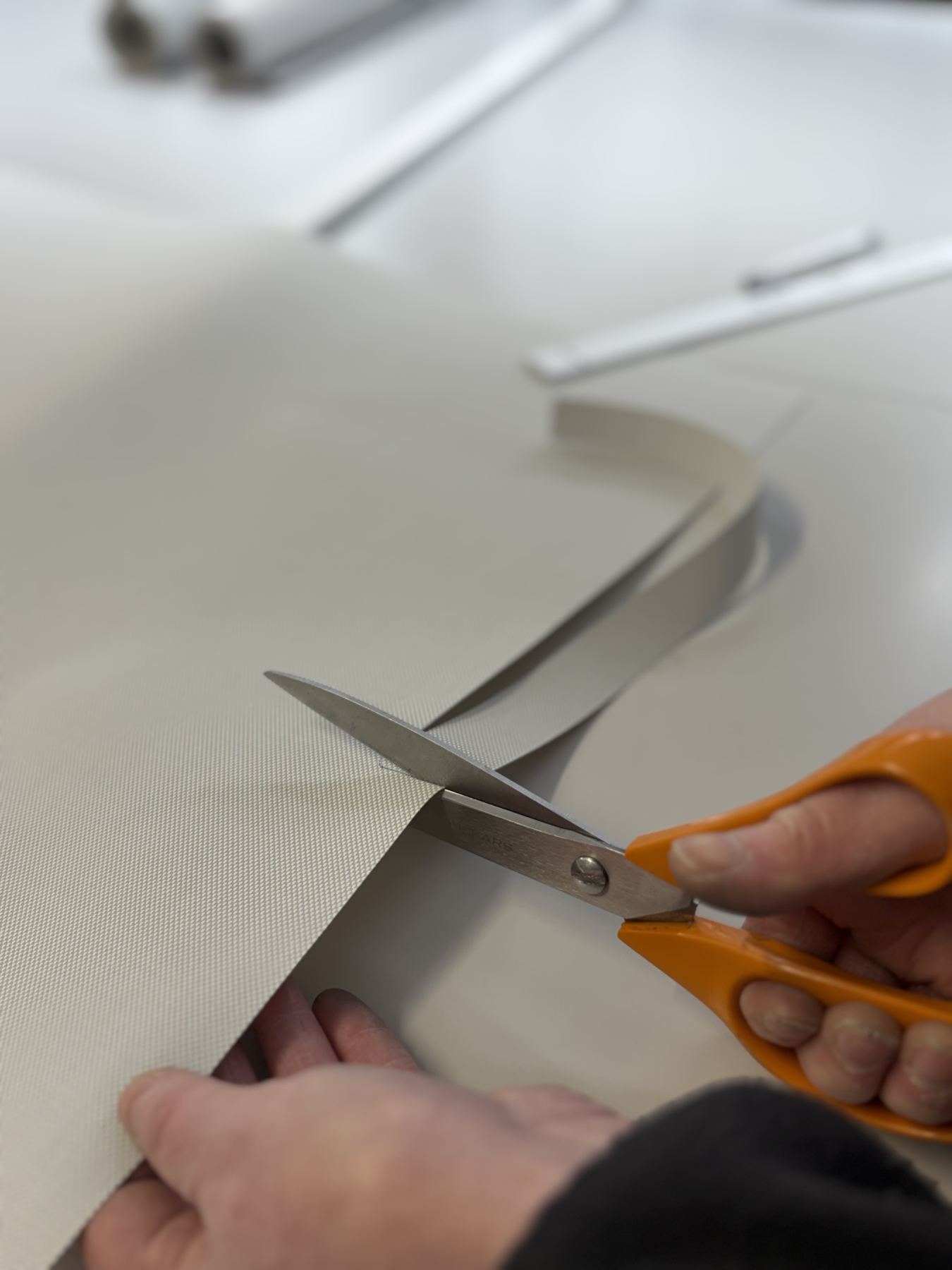 Cutting fabric with scissors at SBI Contracts