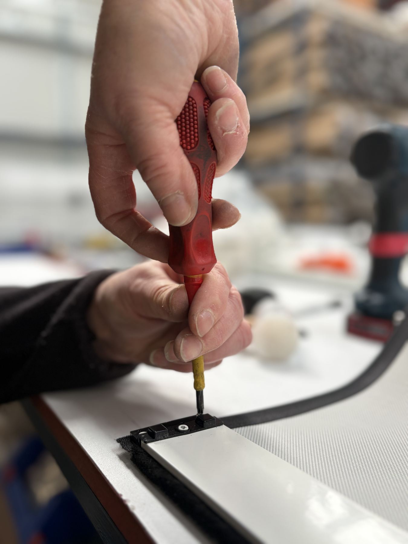 Screwdriver assembling a blind at SBI Contracts
