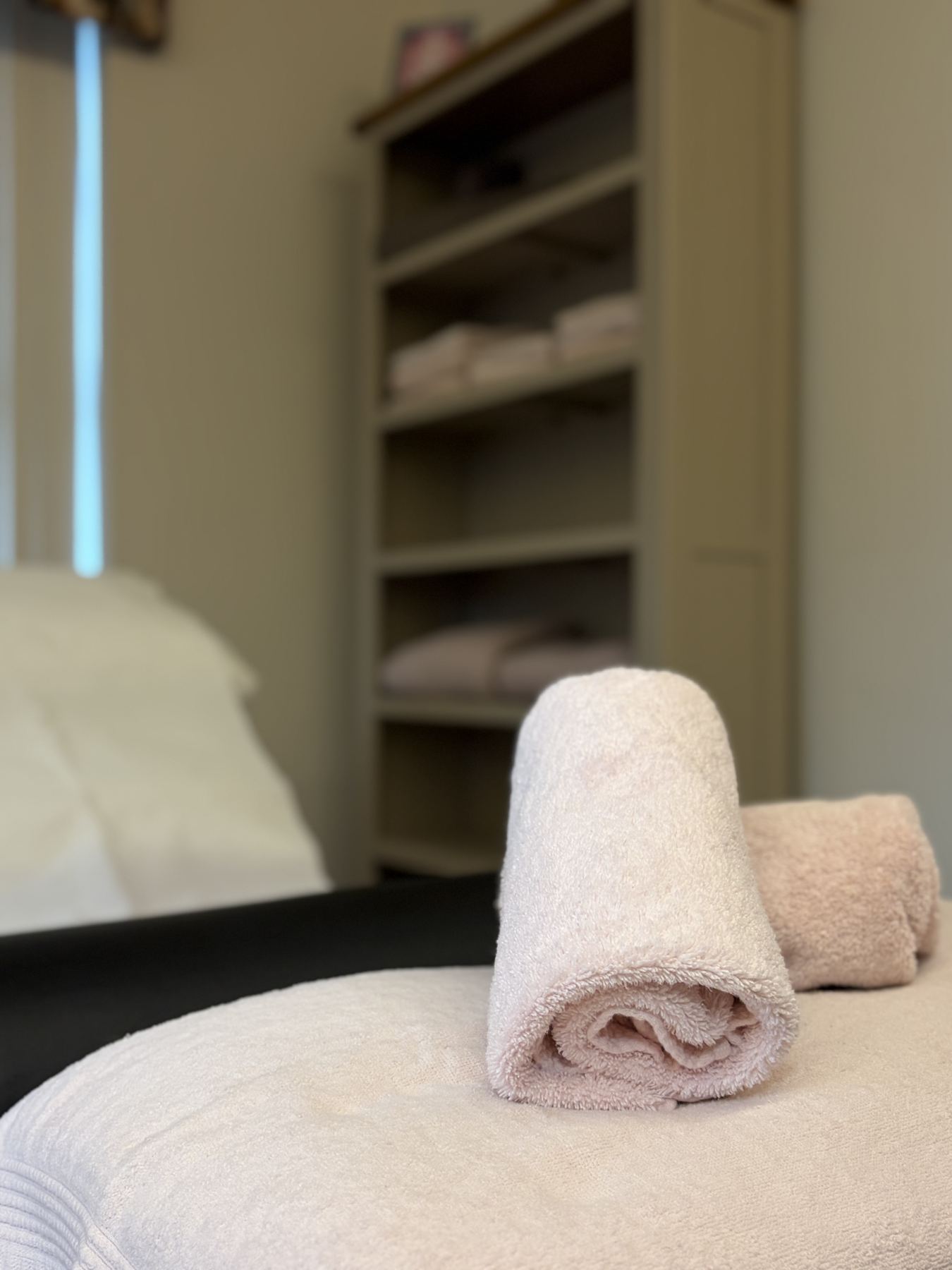Pink towels folded on a table at Care for Cancer
